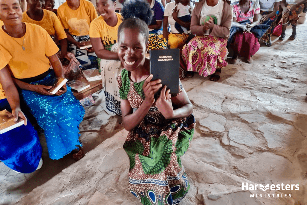 Zambia Bible delivery - joyous lady. Harvesters Ministries