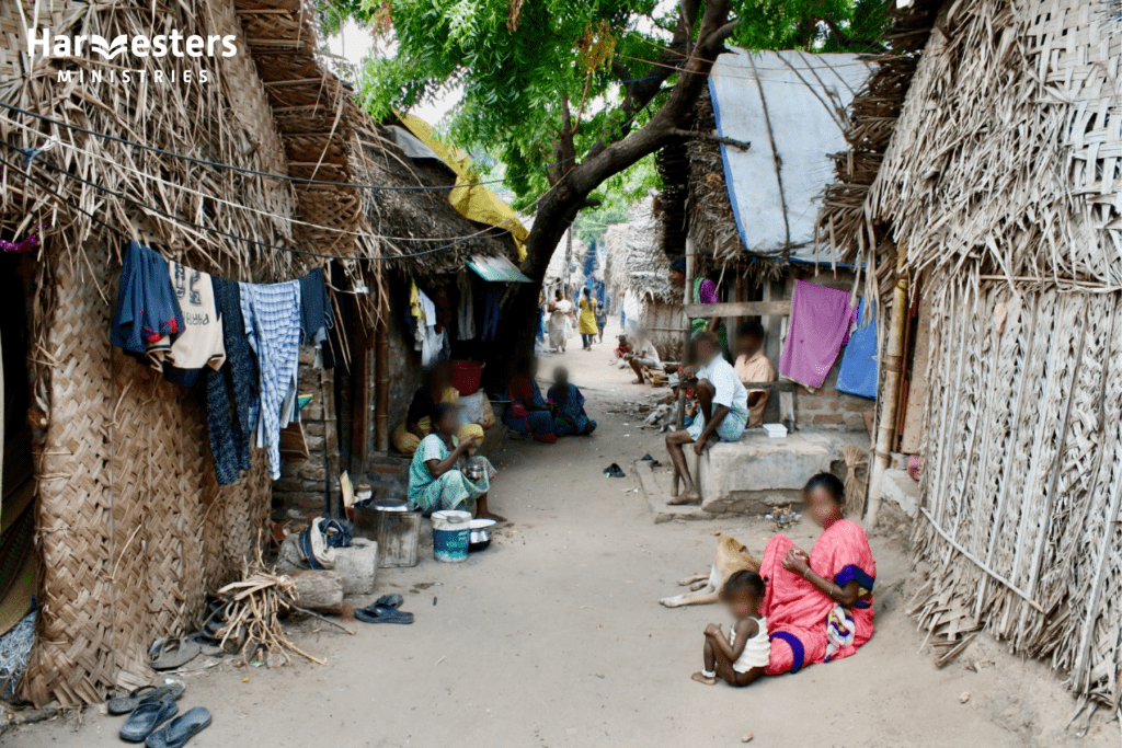 People outside their homes. Harvesters Ministries