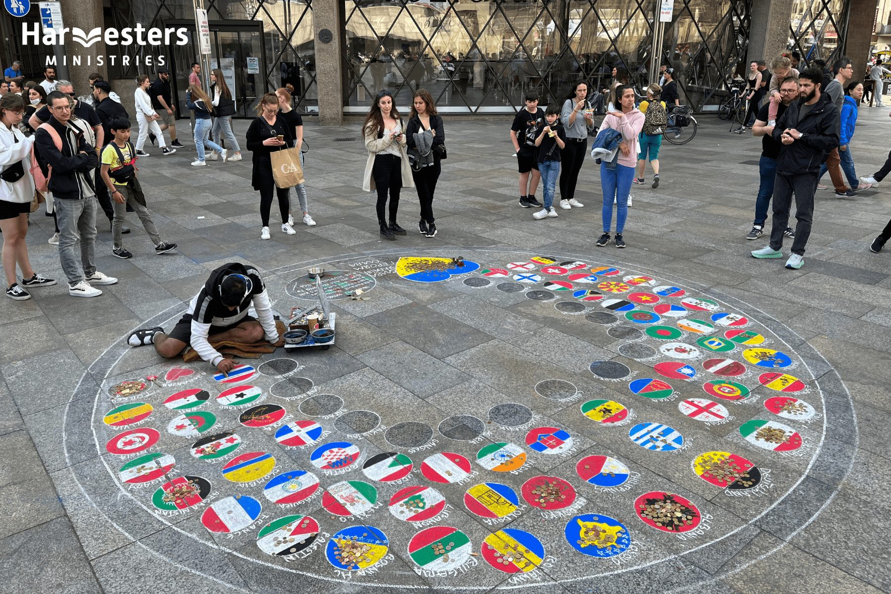 Street artist paints flags of Europe. Harvesters Ministries