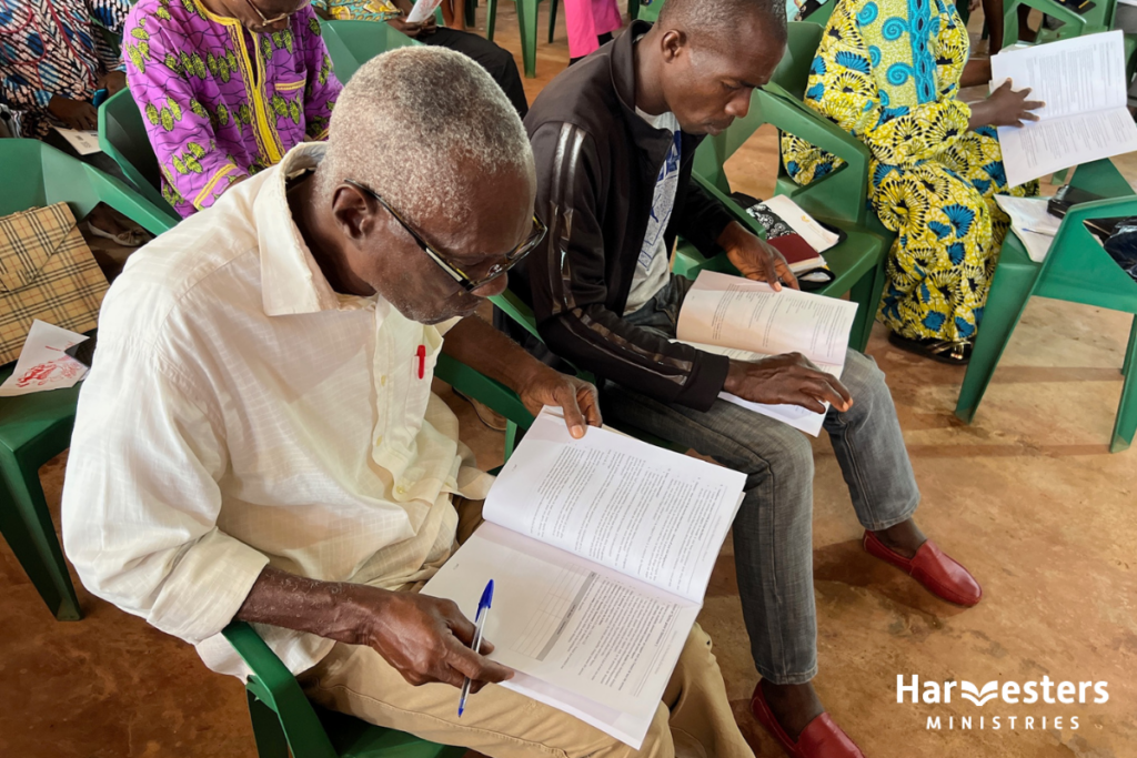 Pastors reading their training manuals. Harvesters Ministries