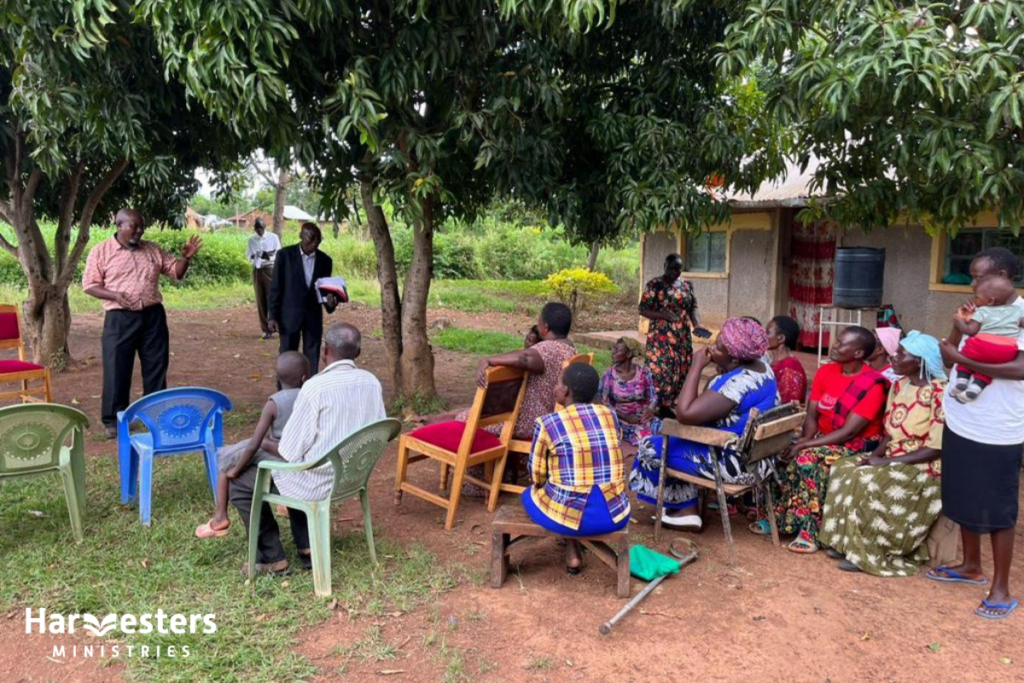 Congregation under tree. Harvesters Ministries