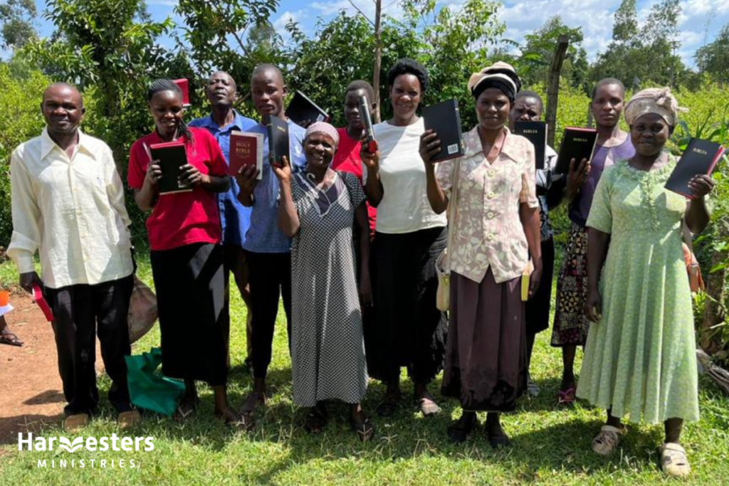 Happy congregation with new Bibles. Harvesters Ministries