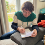 Christophe writing his prayer list. Harvesters Ministries